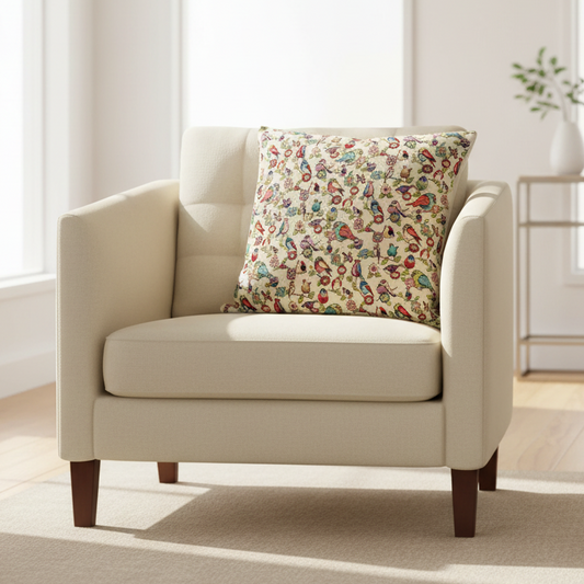 tapestry cushion with birds and floral pattern on an armchair