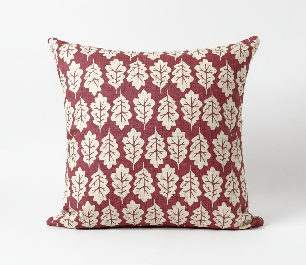 just cushions square cushion with a beige oak leaf print on a subdued red background 
