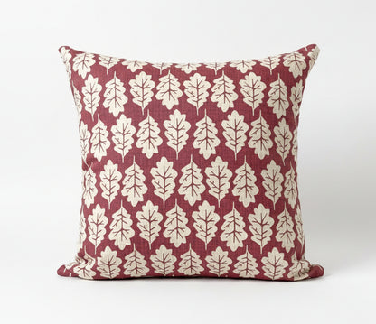 just cushions square cushion with a beige oak leaf print on a subdued red background 